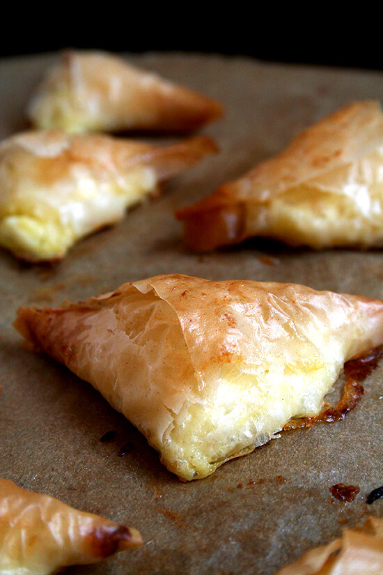 Tiropitas, cheese-and-egg filled fillo triangles, are always a party favorite. What's more, they're not complicated and can be made ahead and stashed in the freezer — perfect to have on hand for entertaining (including Easter Sunday!). // m.simonrockett.com 的平底锅刚刚烤tiropitas。